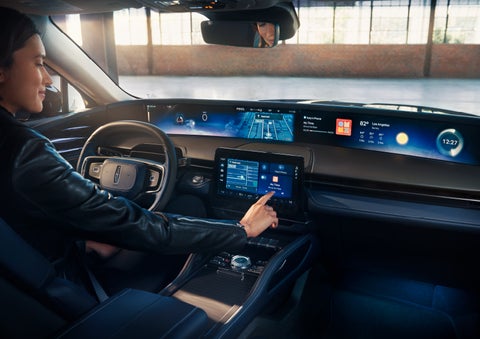 The driver of a 2024 Lincoln Nautilus® SUV interacts with the center touchscreen. | Bob Maxey Lincoln in Detroit MI