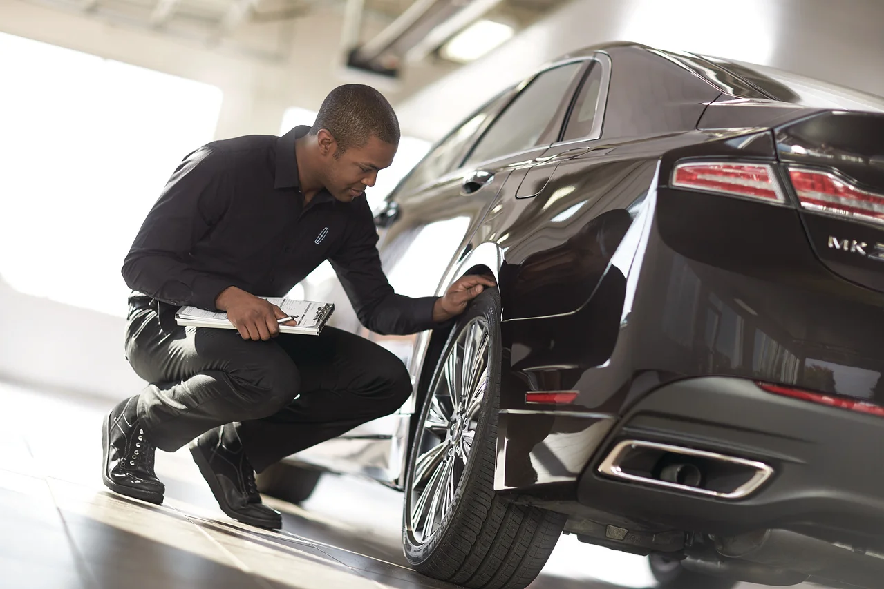 A technician reviewing a Lincoln tire