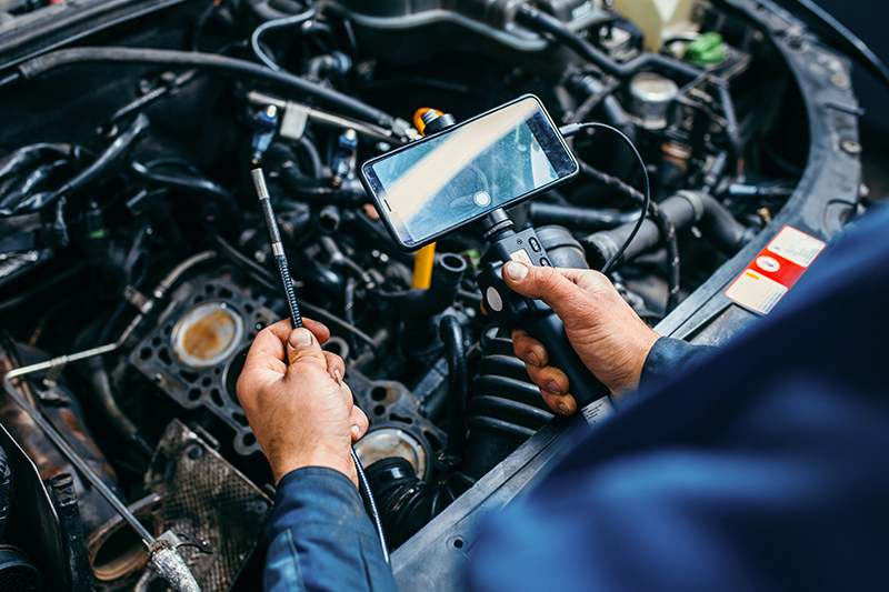 Lincoln technician performing a summer service inspection.