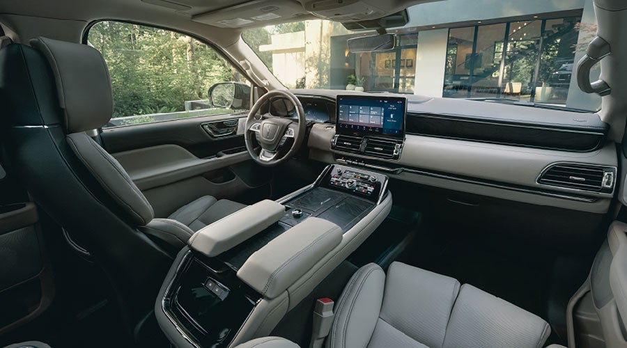 The front cabin inside a 2022 Lincoln Navigator features leather seating surfaces for a comfortable drive