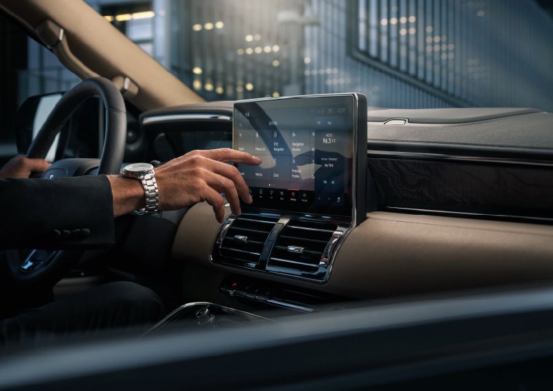 A hand is about to press the personal profiles tile on the settings screen | Bob Maxey Lincoln in Detroit MI