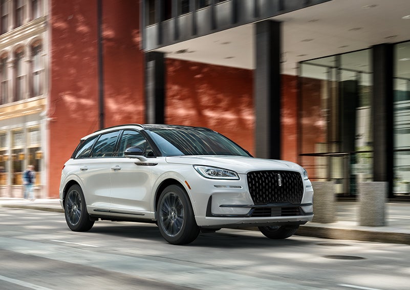 The 2024 Lincoln Corsair® SUV with the Jet Appearance Package and a Pristine White exterior is parked on a city street. | Bob Maxey Lincoln in Detroit MI