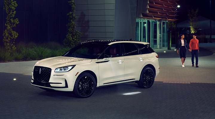 Two people approach a 2024 Lincoln Corsair® SUV featuring the available Jet Appearance Package. | Bob Maxey Lincoln in Detroit MI