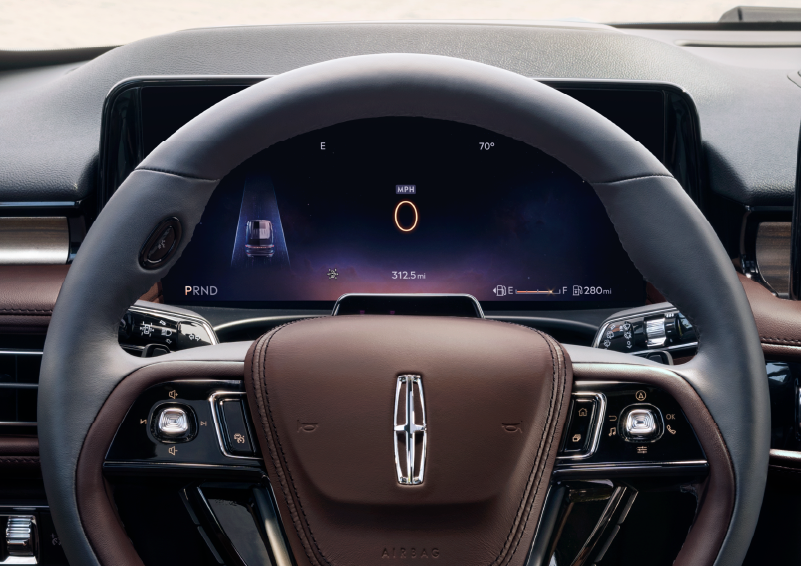 The steering wheel of 2025 Lincoln Aviator® SUV is shown with black and brown accents. | Bob Maxey Lincoln in Detroit MI