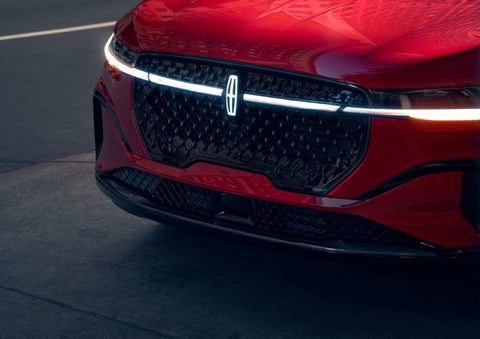 The available front LED light bar and center Lincoln Star logo glow at dusk. | Bob Maxey Lincoln in Detroit MI