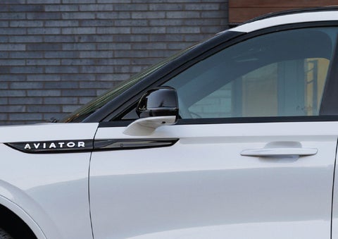 The driver’s side door and fender badging of a white 2026 Lincoln Aviator® SUV are showcased. | Bob Maxey Lincoln in Detroit MI