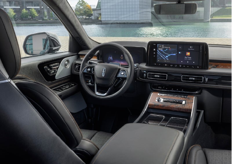 The interior of the 2026 Lincoln Aviator® SUV is shown parked with a view of a harbor through the windshield. | Bob Maxey Lincoln in Detroit MI