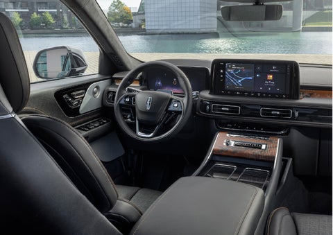 The interior of the 2026 Lincoln Aviator® SUV is shown parked with a view of a harbor through the windshield. | Bob Maxey Lincoln in Detroit MI