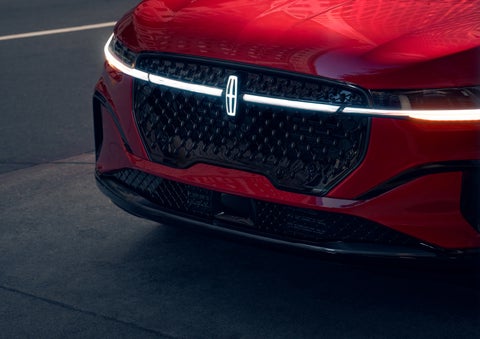 The available front LED light bar and center Lincoln Star logo glow at dusk. | Bob Maxey Lincoln in Detroit MI