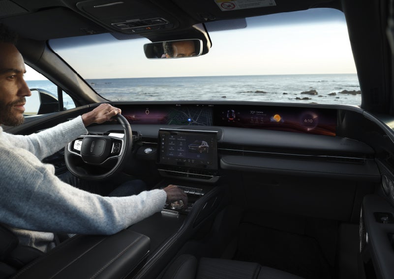 A driver of a parked 2026 Lincoln Nautilus® SUV takes a relaxing moment at a seaside overlook while inside his Nautilus. | Bob Maxey Lincoln in Detroit MI