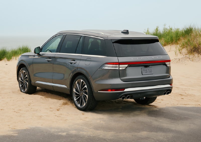 A 2027 Lincoln Aviator® SUV is parked next to sand dunes. | Bob Maxey Lincoln in Detroit MI