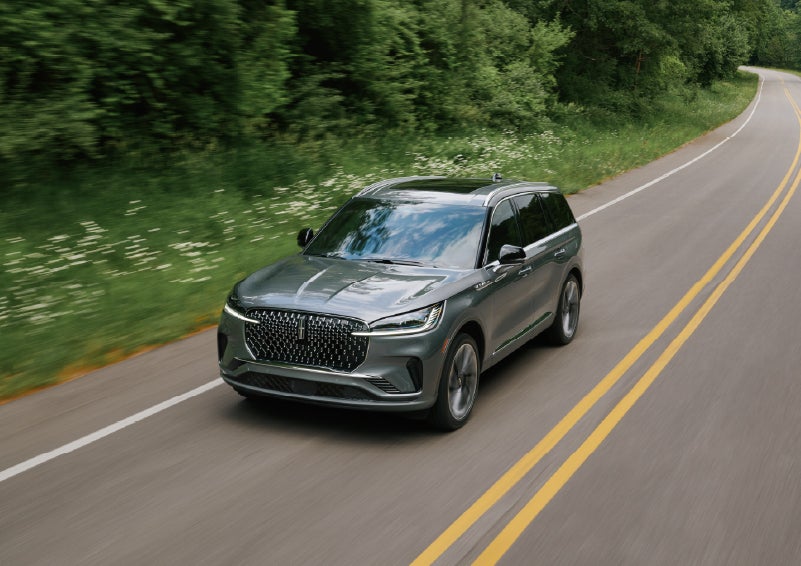A 2027 Lincoln Aviator® SUV is being driven down a road. | Bob Maxey Lincoln in Detroit MI