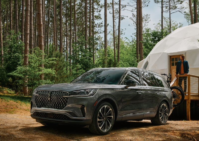 A 2027 Lincoln Aviator® is parked next to a high end glamping site. | Bob Maxey Lincoln in Detroit MI