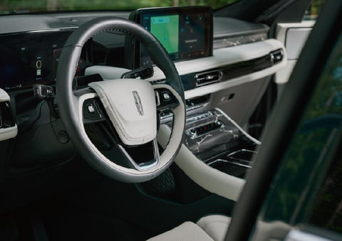 The leather-trimmed steering wheel of a 2027 Lincoln Aviator® Black Label™ SUV. | Bob Maxey Lincoln in Detroit MI