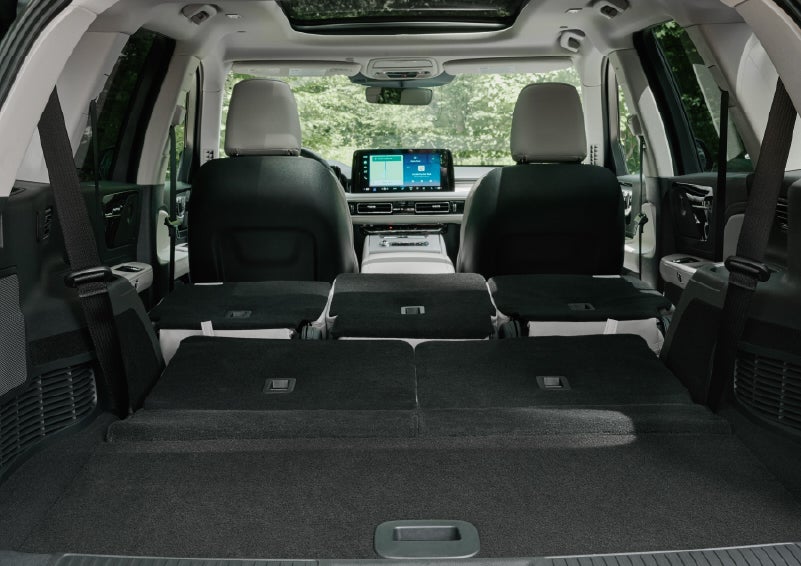 A rear to front view of the interior of a 2027 Lincoln Aviator® Black Label™ SUV shows the third and second rows folded flat | Bob Maxey Lincoln in Detroit MI