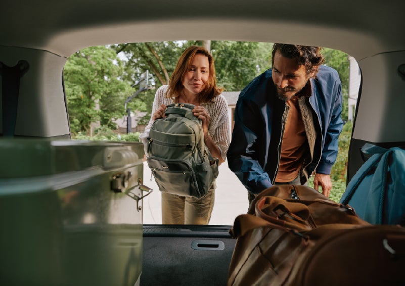 A couple loads luggage into the rear of a 2027 Lincoln Aviator® Black Label™ SUV..e 202 | Bob Maxey Lincoln in Detroit MI