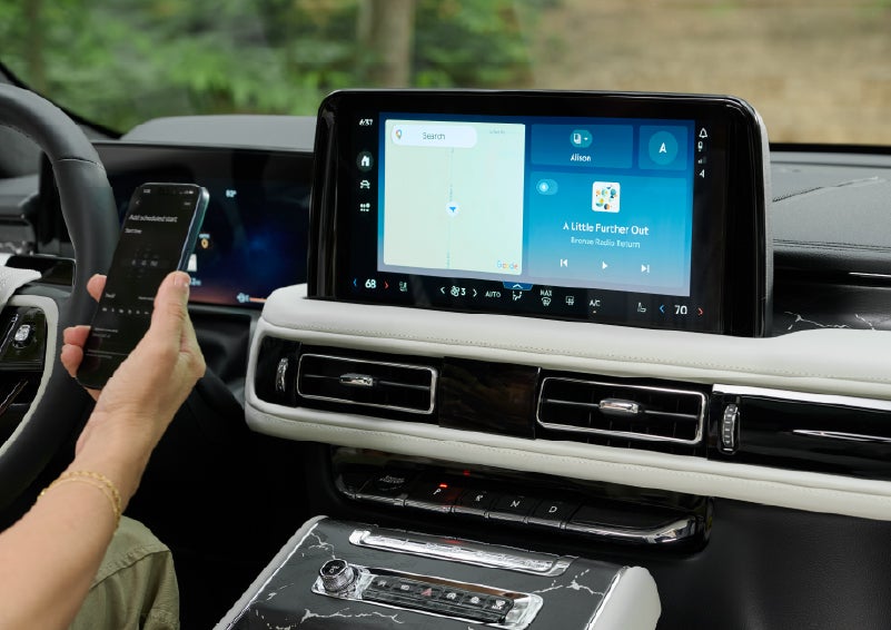 A person pairs thier phone with the center touchscreen of a 2027 Lincoln Aviator® Black Label™ SUV | Bob Maxey Lincoln in Detroit MI
